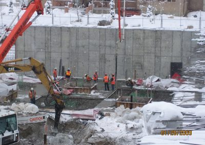 Concrete Crew Working in Snow at Next Construction